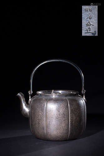 A JAPANESE MELON EDGED LOOP-HANDLED SILVER POT WITH MARK