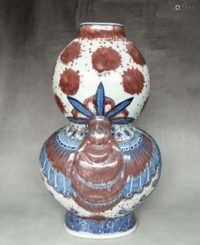AN IRON-RED BLUE AND WHITE DOUBLE-GOURD VASE.MARK OF