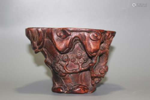A CARVED AGALLOCH WOOD LABATION CUP.