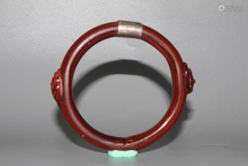 A CARVED GLASS BANGLE.