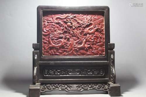 A CARVED CINNABAR LACQUER WOOD DRAGON TABLE