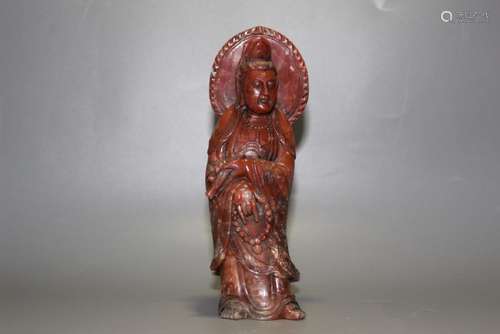 A CARVED SOAPSTONE STANDING GUANYIN.