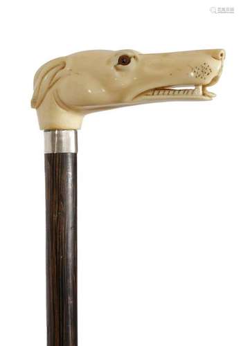 Λ An Edwardian ivory handled walking cane, the han…