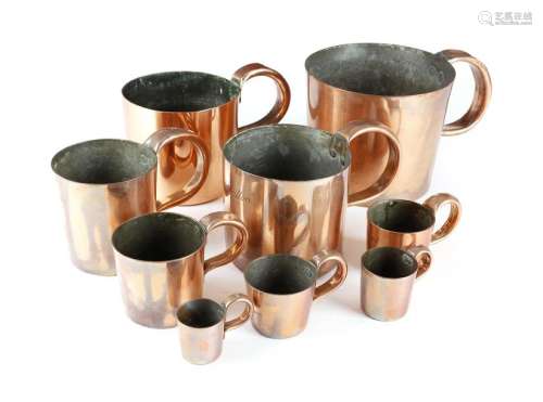 A harlequin set of nine copper navy rum or grog me…