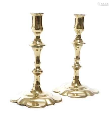 A pair of George II candlesticks, each with a knop…