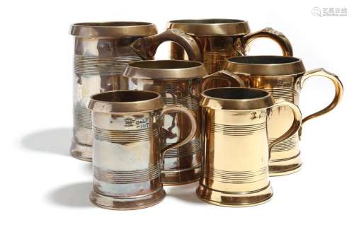 A matched set of six copper tankard measures by Lo…