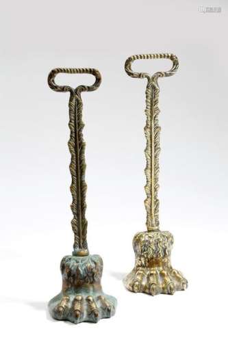 Two Victorian brass lion's paw doorstops, each wit…