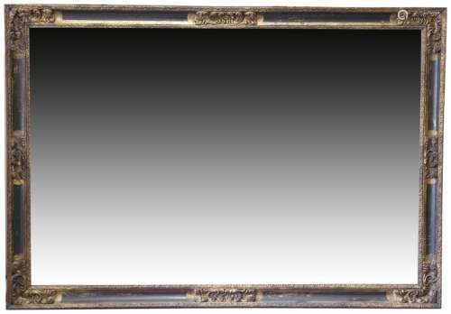 A large giltwood and composition wall mirror, with…