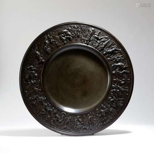A bronzed metal charger in Renaissance style, the …