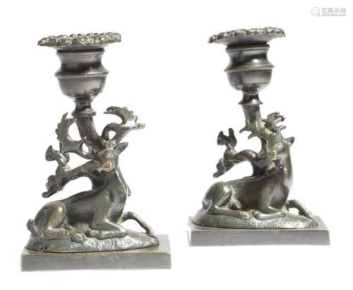 A pair of Regency bronze candlesticks, each modell…