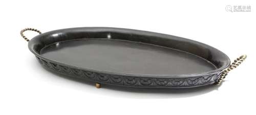 A 19th century ebony oval tray, carved with a styl…