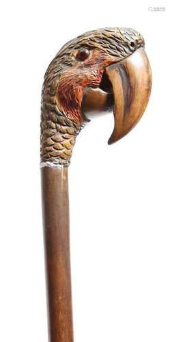 A Folk art walking cane, the handle carved with a …