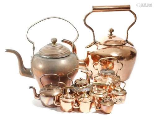 Ten copper kettles, some with brass handles, one w…