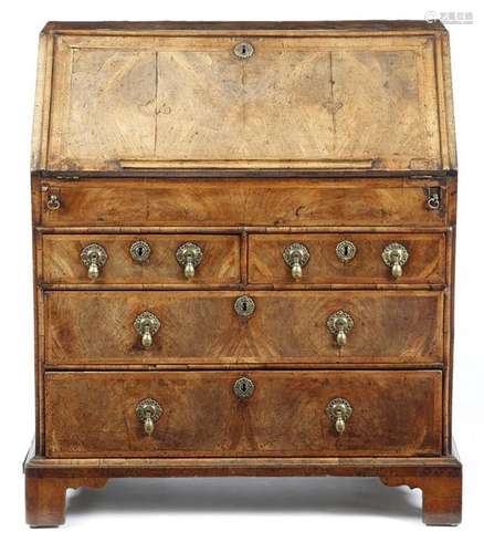 A George I walnut bureau, with cross and feather b…