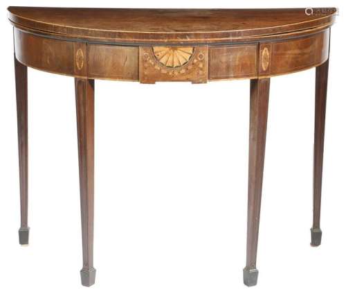 A George III mahogany demi lune tea table in the m…