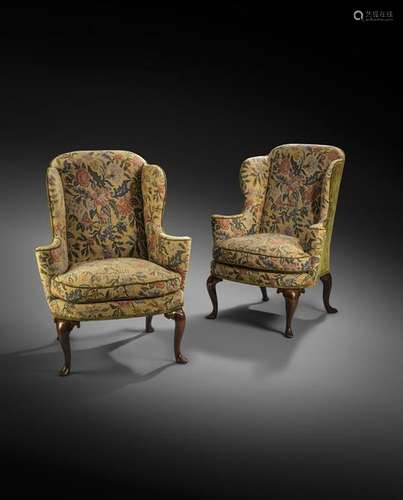 A pair of George I walnut wing armchairs, later up…