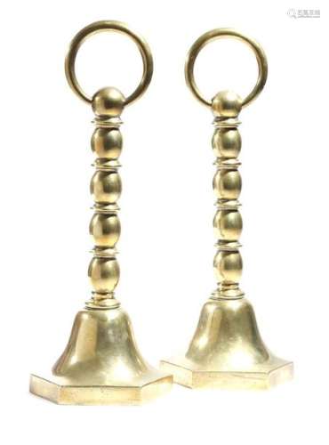 A pair of Victorian brass doorstops, each with a s…