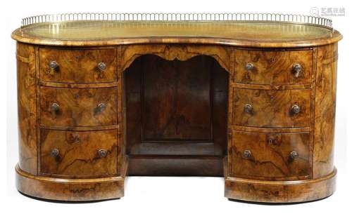 A Victorian walnut kidney shape desk, the top with…