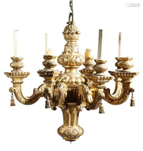 A carved giltwood eight light chandelier in George…