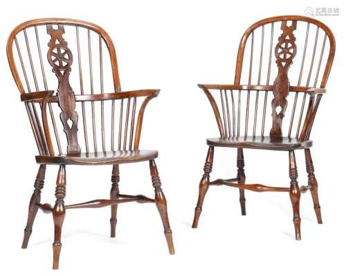 A matched pair of yew high back Windsor armchairs …