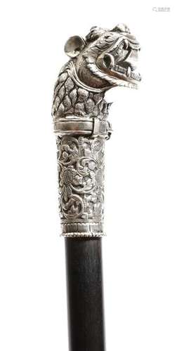 A Burmese silver handled walking cane, the lion's …