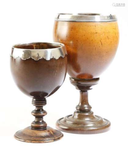 Two 18th century coconut cups, each with a silver …