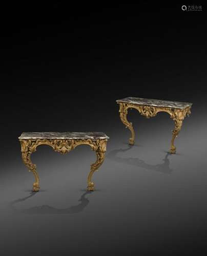 A pair of Italian Rococo giltwood console tables, …