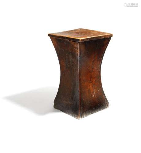 A George III elm box stool, of waisted shape, the …