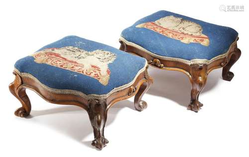 A pair of Victorian walnut footstools, each with a…