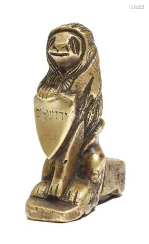 A bronze model of a heraldic seated lion, holding …