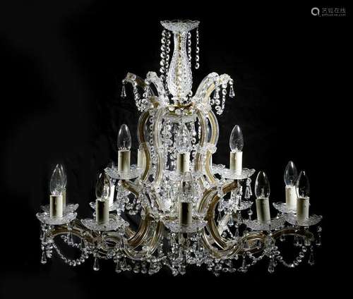 A glass and gilt brass sixteen light chandelier, o…