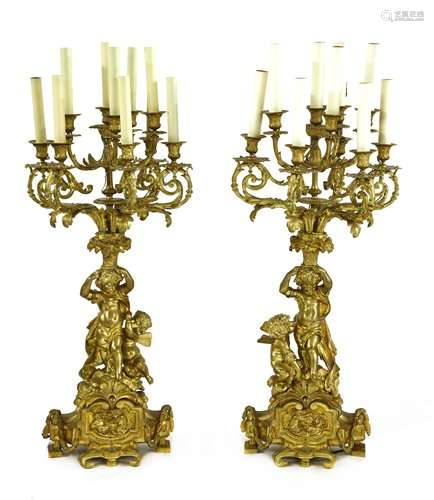 A pair of gilt bronze ten light figural candelabra…