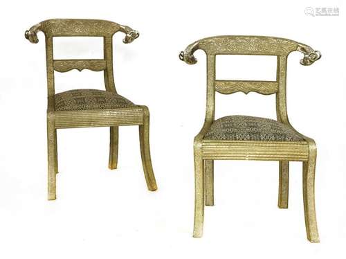 A pair of Indian white metal clad side chairs, the…