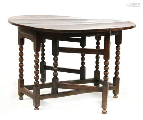 A Charles II oak gateleg dining table, the oval dr…