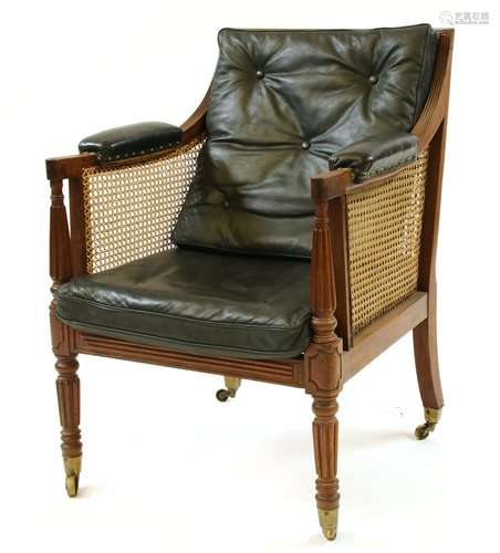 A George III bergère library chair, the cane back …