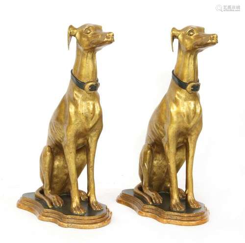 A pair of parcel gilt seated whippets, of recent m…