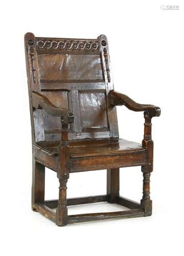 An oak panel back open armchair, early 17th centur…