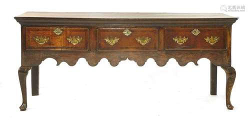 A George II oak and walnut low dresser, with three…