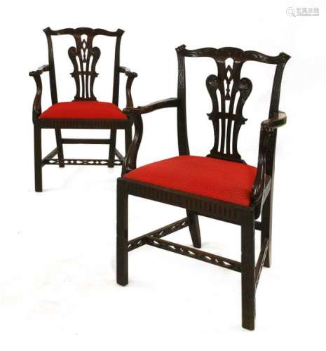 A pair of Chippendale style mahogany elbow chairs,…