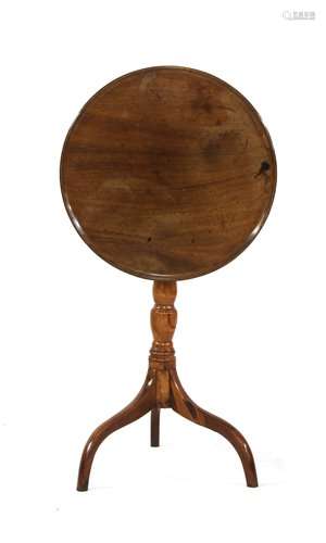 A George III mahogany tripod table, the dished top…