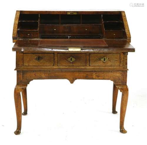 A figured walnut bureau on stand, early 18th centu…