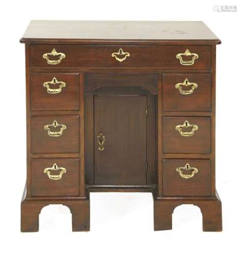 A George III mahogany kneehole desk, seven drawers…
