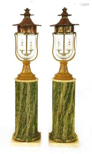 A pair of lamps and columns, 20th century, each wi…