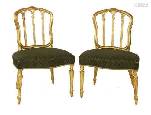 A pair of Georgian gilt side chairs, with arched o…