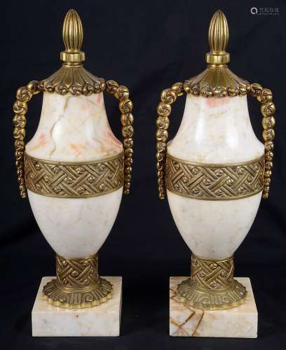 A Pair of Gilt Bronze and Onyx Lidded Vases: With geometric designs,