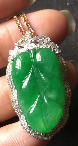 A GREEN JADEITE CARVED LEAF PENDANT, TYPE A