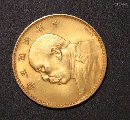 A GOLD CASTED FIGURE HEAD PATTERN COIN