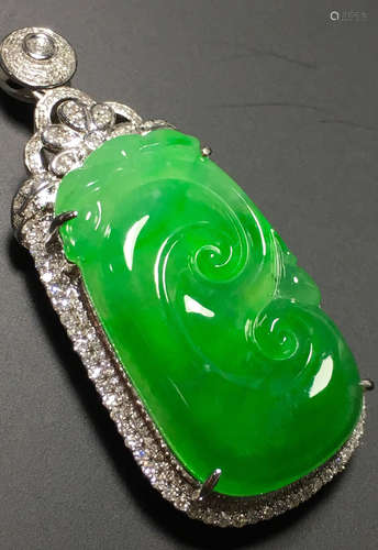 A GREEN JADEITE CARVED AUSPICIOUS PENDANT, TYPE A