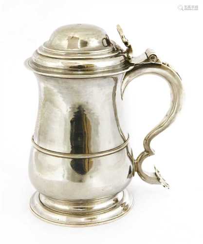 A George II provincial baluster shape tankard and cover,