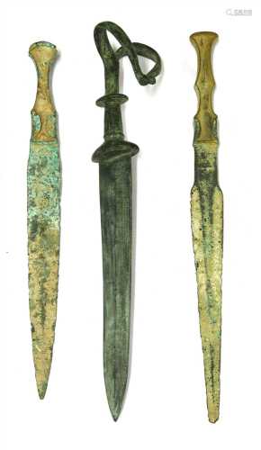 Antiquities: three bronze daggers,